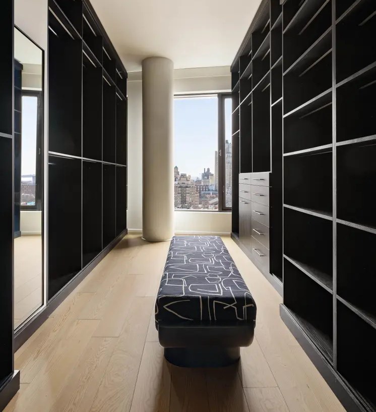 Walk-in closet with oak flooring